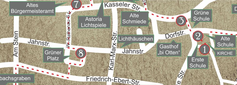 Auf der Rückseite des Platzes öffnet sich ein kleiner Weg zur Friedrich-Ebert-Str., am unteren Ende der rechts liegenden Straße Am Stein gibt es das nächste Schild zu bestaunen.